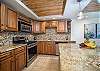 Fully equipped kitchen with custom cabinetry and granite counters.