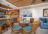 Glass-top dining table with seating for four, framed by bamboo accents.