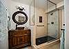 Spa-like bathroom with a walk-in glass shower and custom vanity.