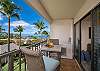 A cozy lanai retreat surrounded by palms and ocean blue.