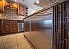 Under-counter stainless refrigerator blends seamlessly with the space.