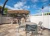 Covered BBQ pavilion with tables and chairs.