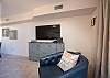 Living area with flat-screen TV, accent chair, and decor.