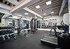 Fully equipped fitness center with weights, machines, and treadmills.