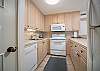 Fully equipped kitchen with modern appliances and ample cabinet space.