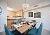 Bright dining area with coastal décor and kitchen breakfast bar.