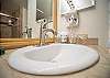 Modern bathroom sink with bright lighting and convenient amenities.