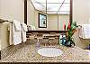Spacious vanity with granite counters and full mirror.