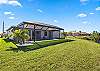 Large, fenced yard with views of a freshwater canal.