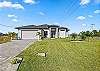 Paved driveway for parking and beautiful landscaping.