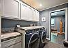 Laundry room with a washer, dryer, and wash basin. 