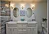 1st bathroom with a walk-in shower, toilet, and double sink.