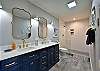 Master bedroom attached bathroom with walk in shower and double sink.