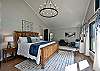 The 4th bedroom is a master bedroom with a king bed, closet, tv, and an attached bathroom