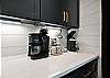 Kitchen with a drip coffee pot or individual Keurig cups.