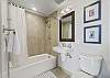 Secondary bathroom with bathtub/shower combination.