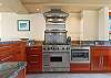 A chef's dream kitchen.  All stainless steel appliances with a wolf gas stove/oven combination.