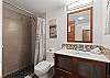 Nicely updated bathroom with a tiled walk-in shower stall.