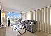 Sleeper sofa in the living room.  Bedroom behind the accordion doors.  Can be completely opened to allow a more expansive view and open room feeling or completely closed for more privacy in the bedroom.