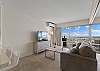Living room with sleeper sofa, flat-screen TV.  Breakfast bar area just to the left
