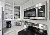 New kitchen ware including plates, cutlery, coffee maker, toaster oven and full-sized stainless steel appliances!