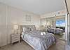 Comfortable king-sized bed and ample closet space to the right.