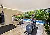 More work-out equipment located outside and adjacent to the swimming pool.