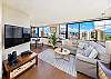 spacious open-concept living room area with 42&quot; inch flat-screened TV, sectional sofa, end table with lamp provide a comfortable living environment.