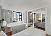 Bedroom provides views and can be separated or combined with the living room area with movable partition doors.