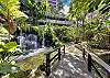 Enter through the secured entry gate and over the bridge and you have entered into one of the most tropical, lush environments complete with a waterfall and koi.