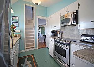 Kitchen with staircase to bedroom with 1 twin