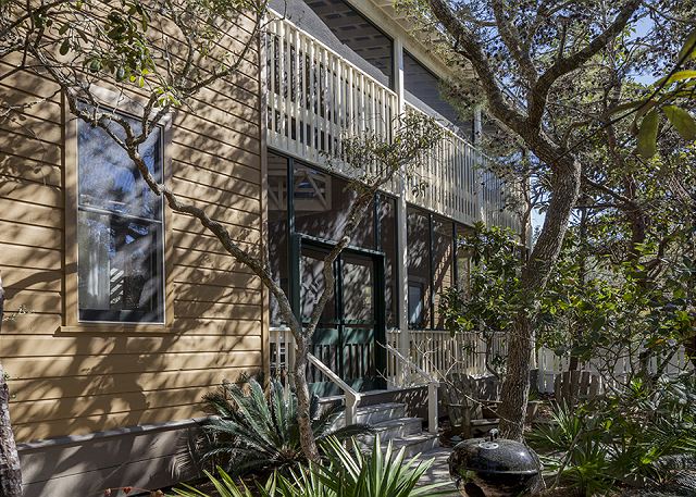 The screened porch looks out to a lush garden of native Florida The screened porch looks out to a lush garden of native Florida