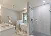 Primary ensuite bathroom double vanity, walk-in shower, relaxing soaking tub, and toilet