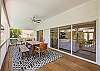 Outdoor dining area within pool cage