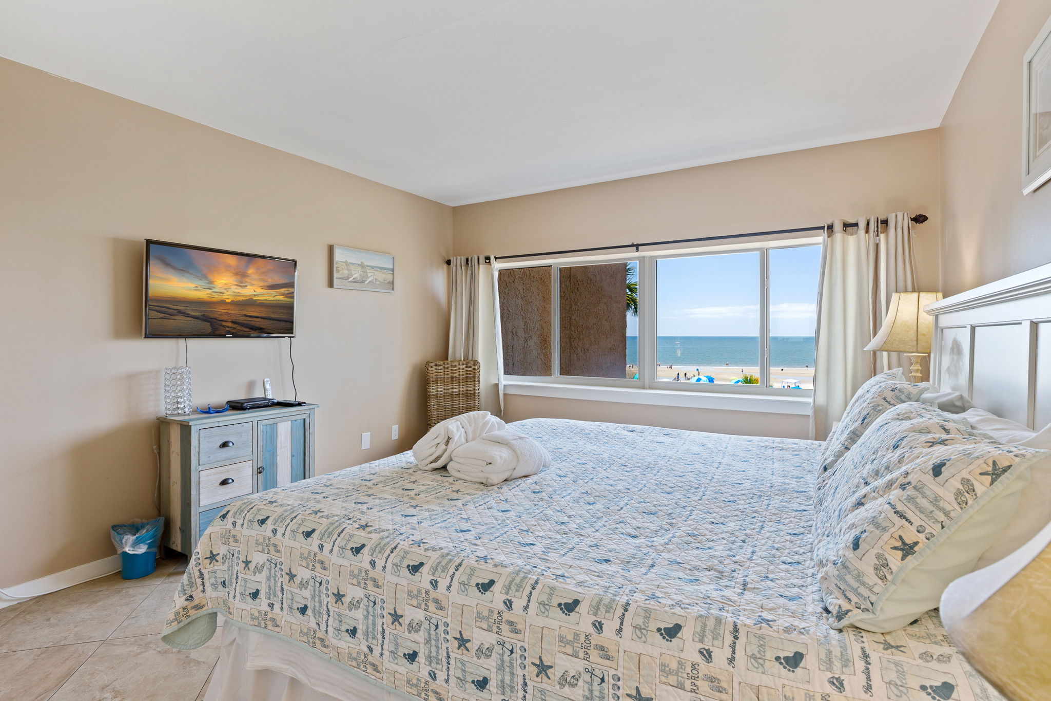 Master bedroom with King bed, flat screen TV, and private bath