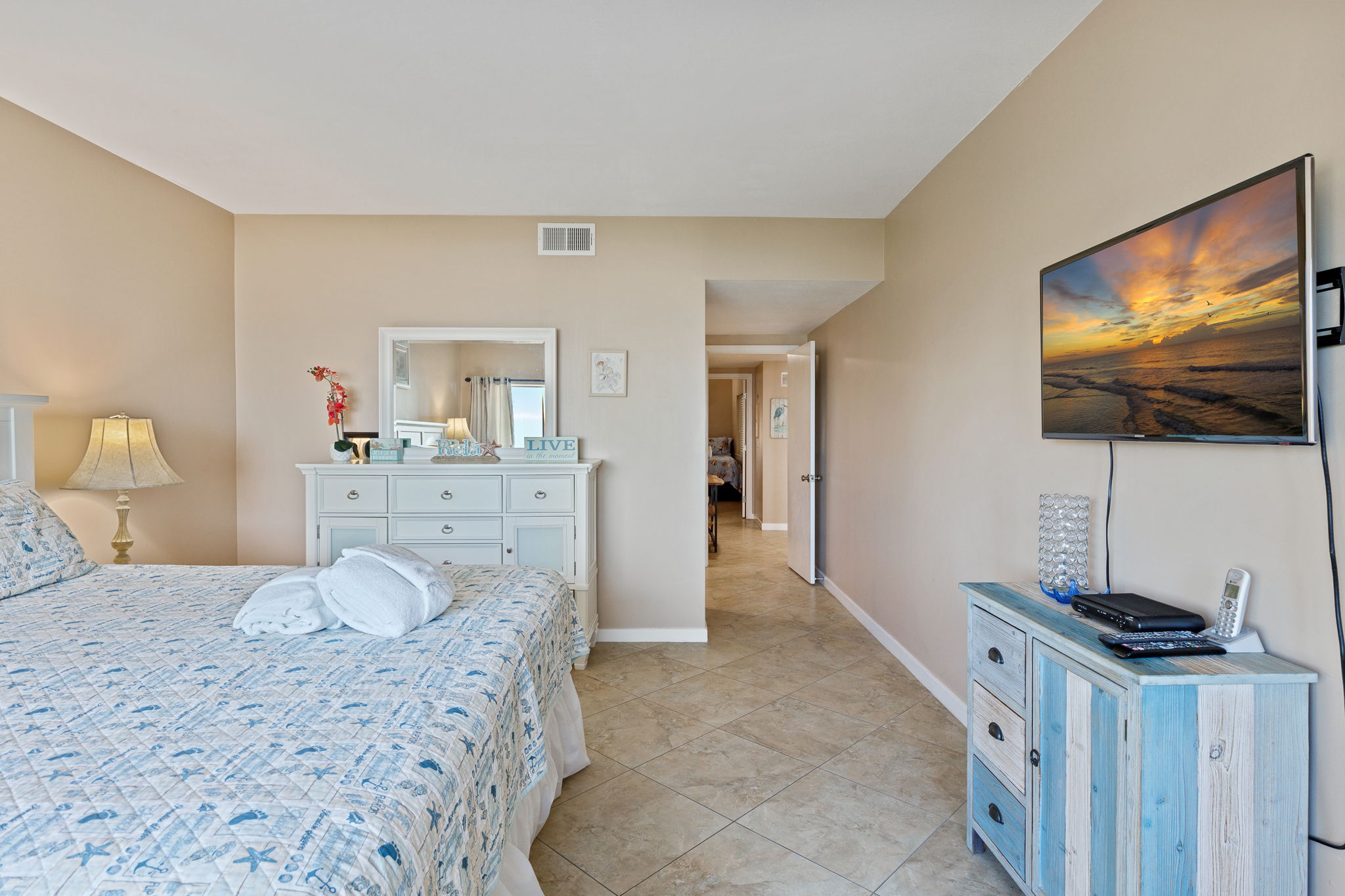 Master bedroom with King bed, flat screen TV, and private bath