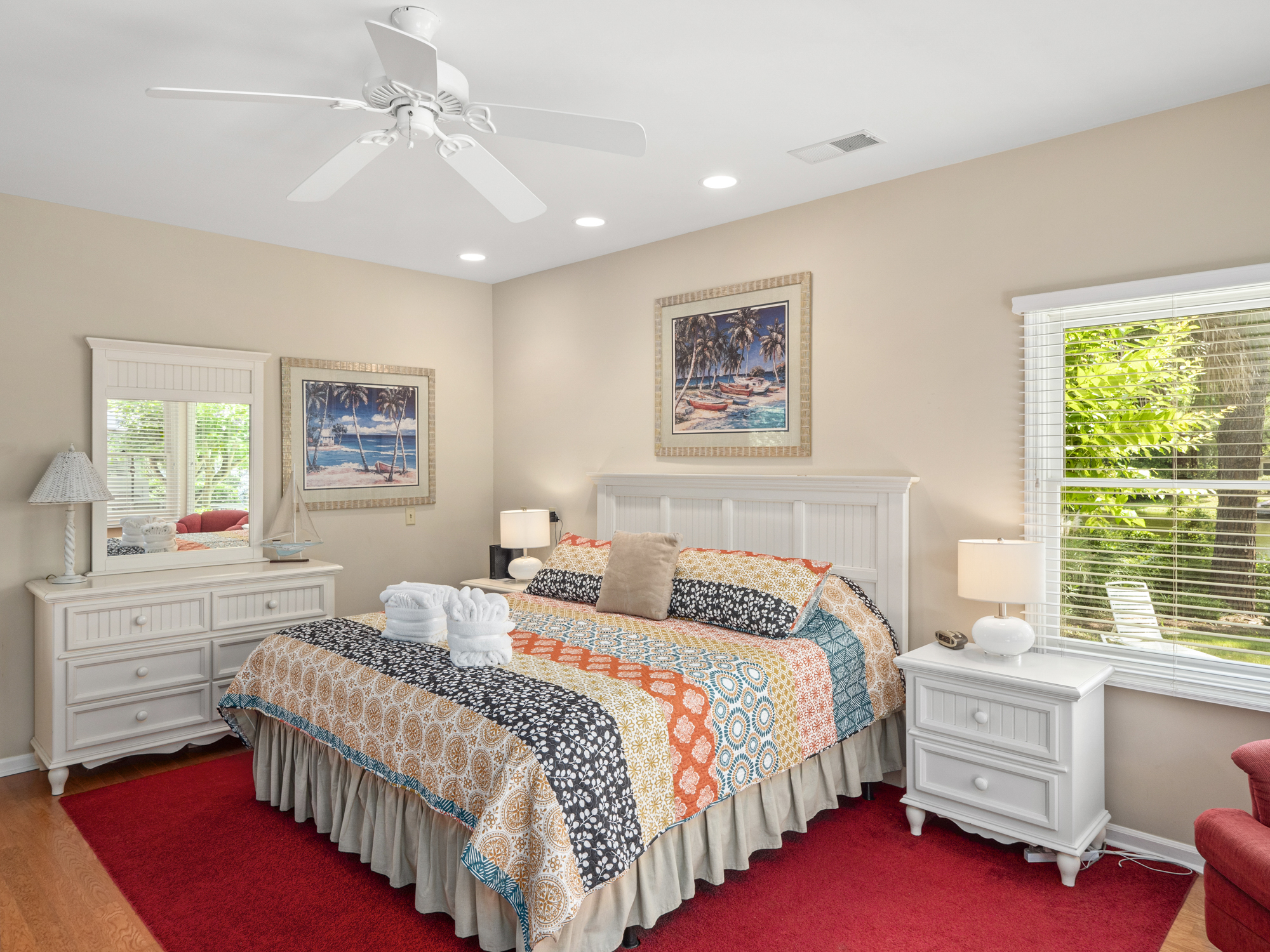 Master bedroom with king bed, TV, and private bath