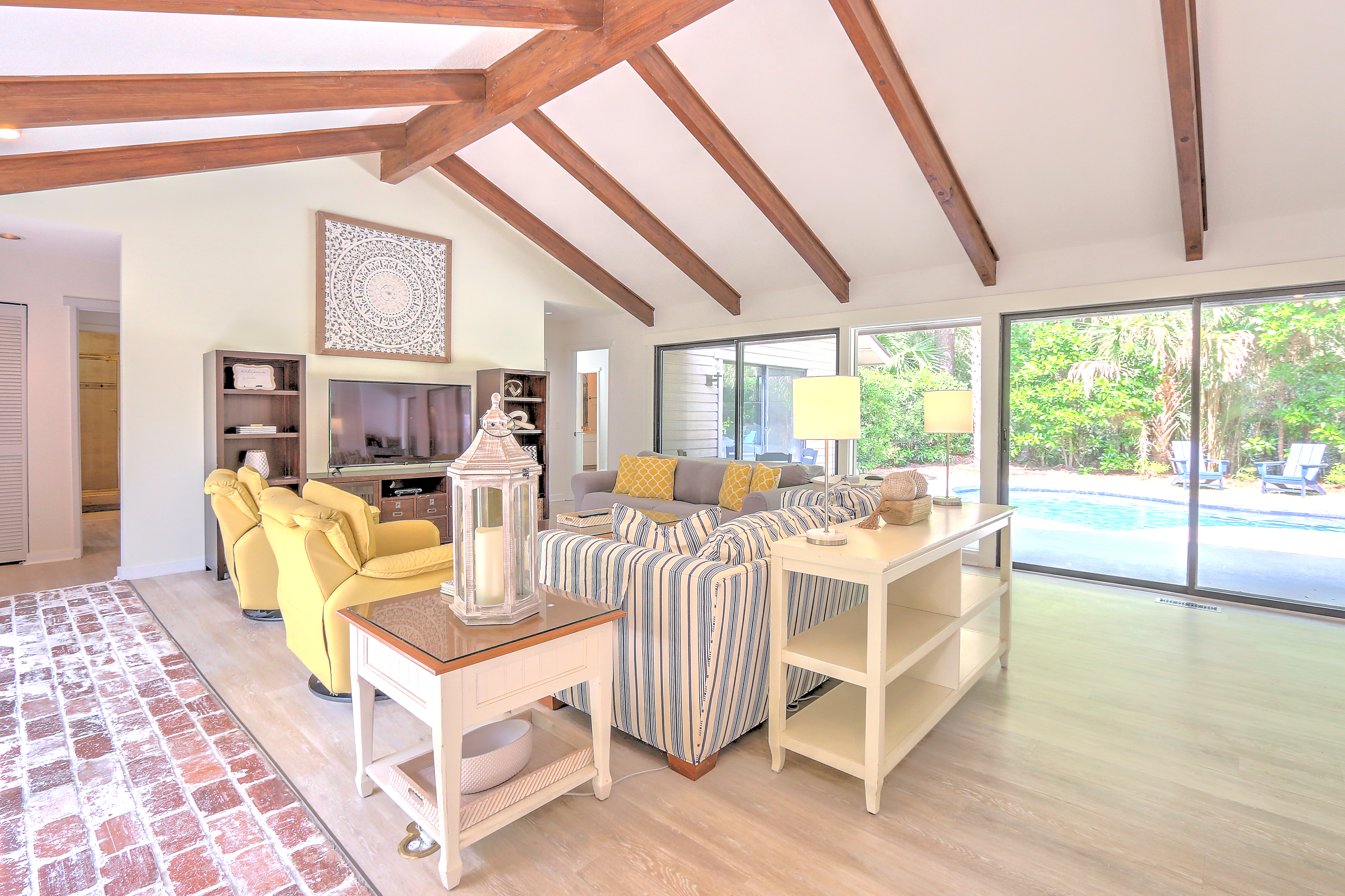 Living Room with Flat Screen TV and Pool Views