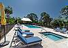 Large custom sun deck surrounding the pool