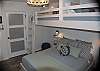 Guest bedroom designed a a children's space with ultimate functionality twin bunks and a queen size bed below