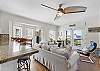 Spacious, comfortable living room with beautiful ocean views. Multiple windows fill the space with natural light.