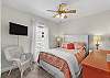 Queen bedroom with TV and an adjoining bathroom shared with the third bedroom.