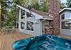 Wraparound deck with a hot tub and an entry door to the kitchen. This house is not permitted to have a BBQ.