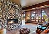 Classic stone hearth fireplace in the formal living space and library