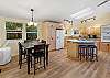 Full open kitchen with bar stool seating and 4 person breakfast table 