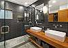 Guest bathroom with dual sinks and a shower on main floor 
