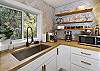 Gourmet kitchen for the chef-at-heart
You'll find the kitchen is well stocked with spices and quality cookware for guests to prepare meals during their stay.
An island with seating and stainless-steel appliances makes this kitchen a cook's dream. 