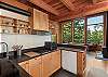 Kitchen with mini-fridge, toaster oven, two range stove and coffee maker. 