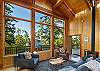Relax around the fireplace in this open concept cabin with partial water views.