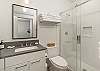 Bathroom #1 located across from Bedroom #1 boasts a spacious shower and modern fixtures. 